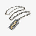 Flat lay of the Abundance necklace with a silver chain, displaying the rectangular tag design