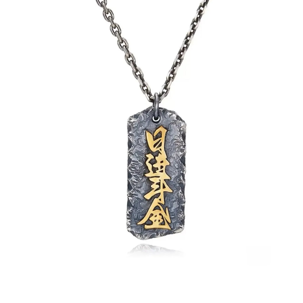 Front view of the Abundance necklace featuring the Chinese characters "Ri Jin Dou Jin" in gold, symbolizing daily wealth
