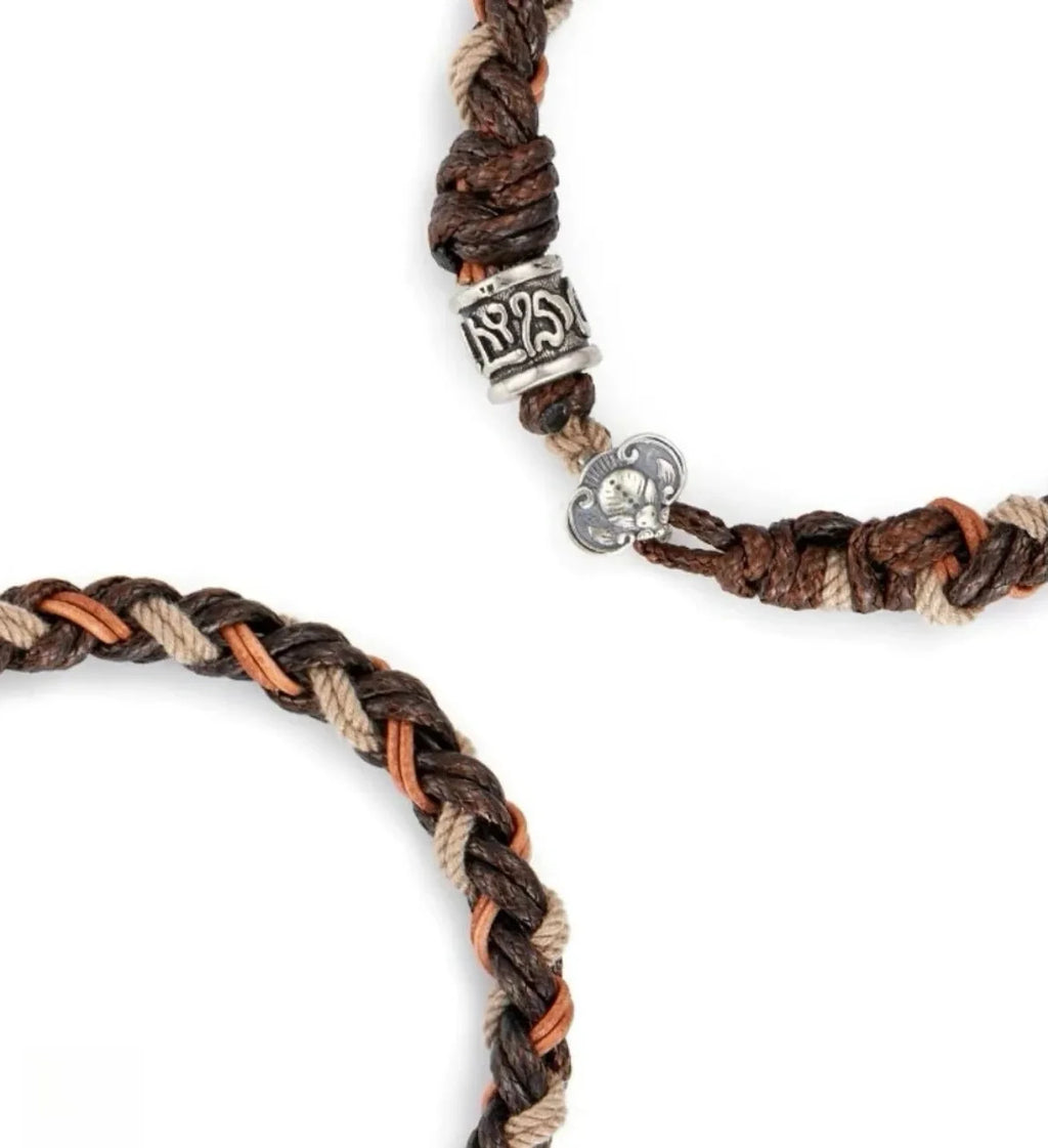 Top-down view displaying the circular shape and the "Om Mani Padme Hum" inscription on the silver bead