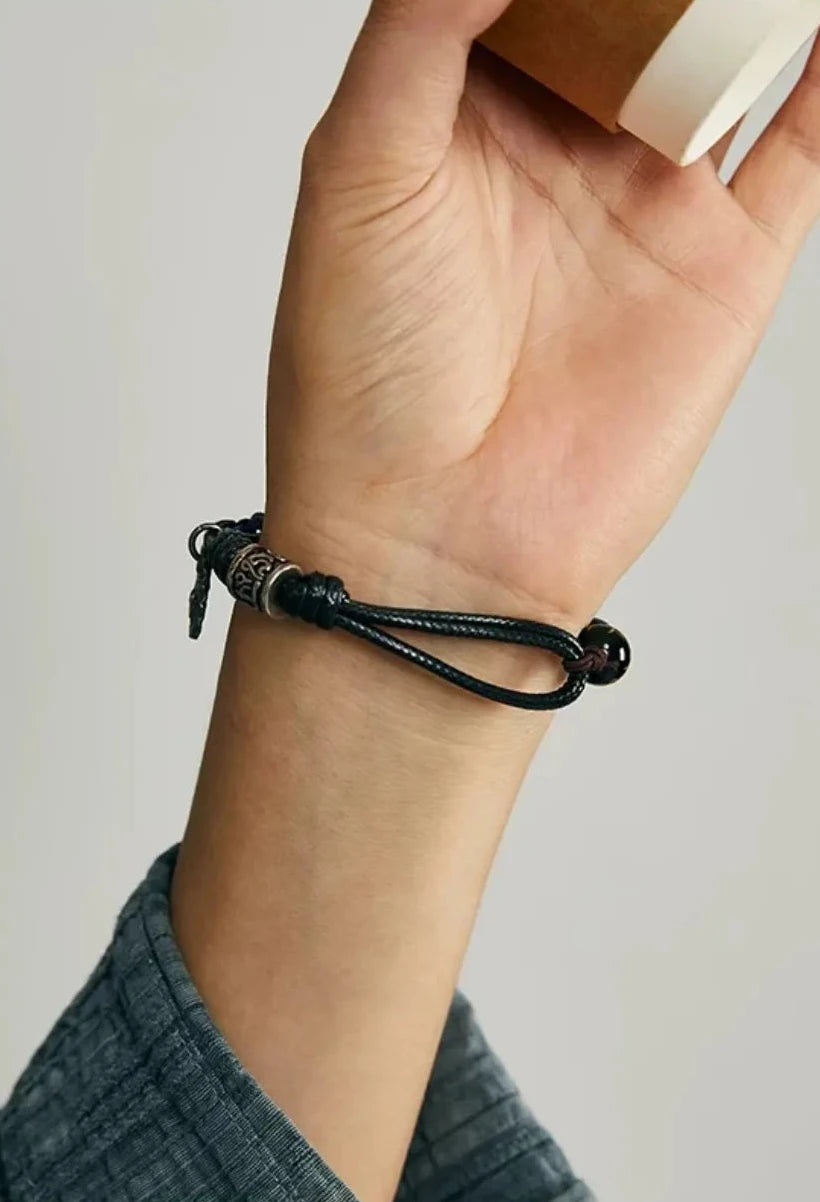 A moody styling shot of the Sunyata bracelet, emphasizing its Zen aesthetic and fit for a modern spiritual look