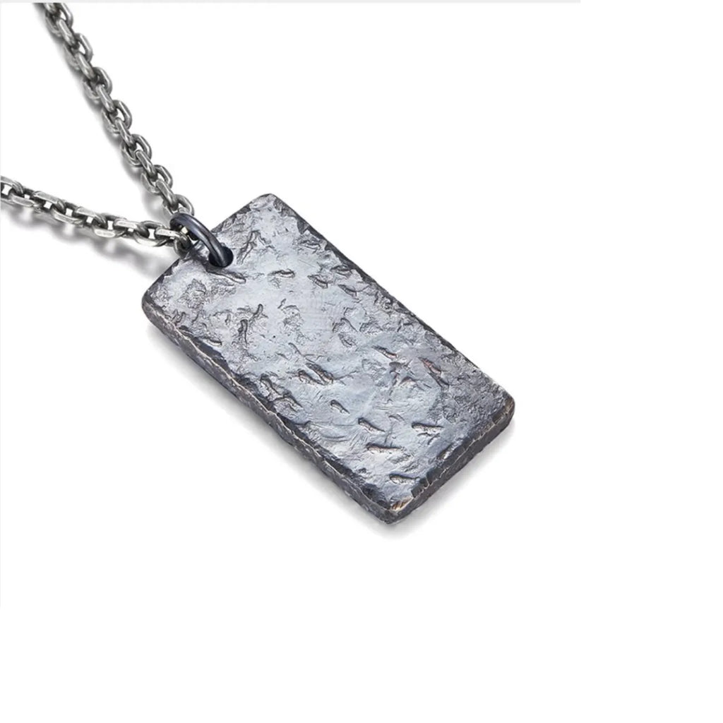 Back view of the ancient coin necklace pendant featuring a rugged, oxidized crater texture