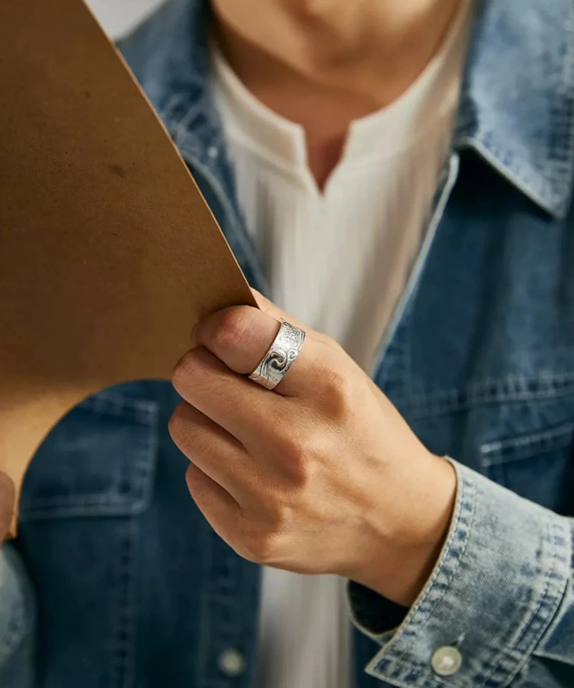 Close-up of the silver Aspiration Ring on a male hand, emphasizing the vintage finish and unique statement piece appeal