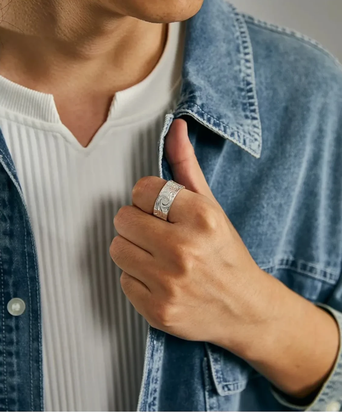 Model wearing the silver Aspiration Ring styled with a denim jacket, showcasing an artistic band for men