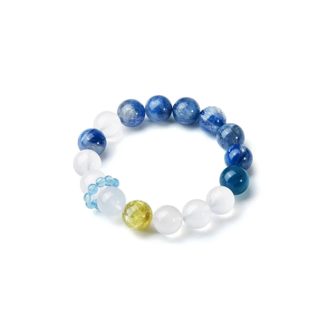 Side profile focusing on the unique "satellite" design feature: a small ring of aquamarine beads encircling a white crystal