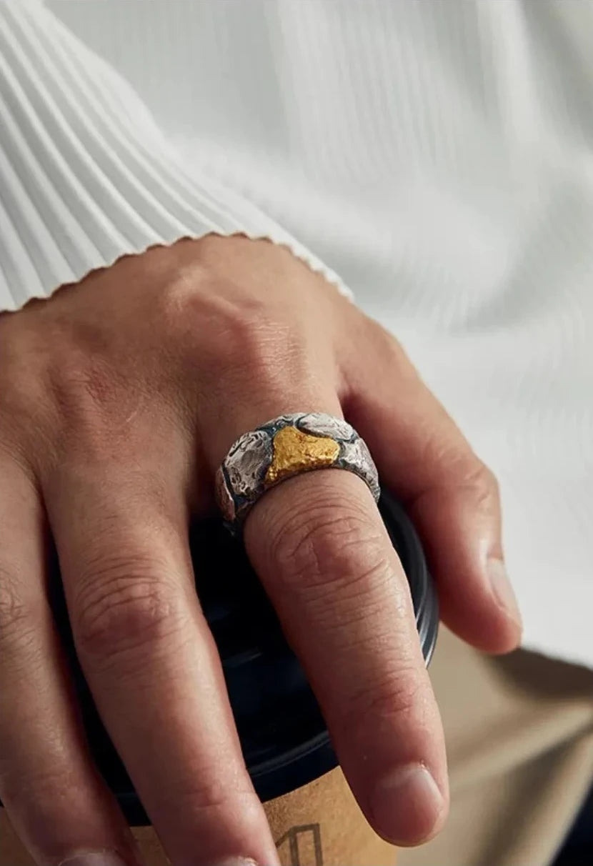 Close-up of the Bedrock Ring on a finger, emphasizing the artisan statement jewelry quality and unique gold-silver contrast