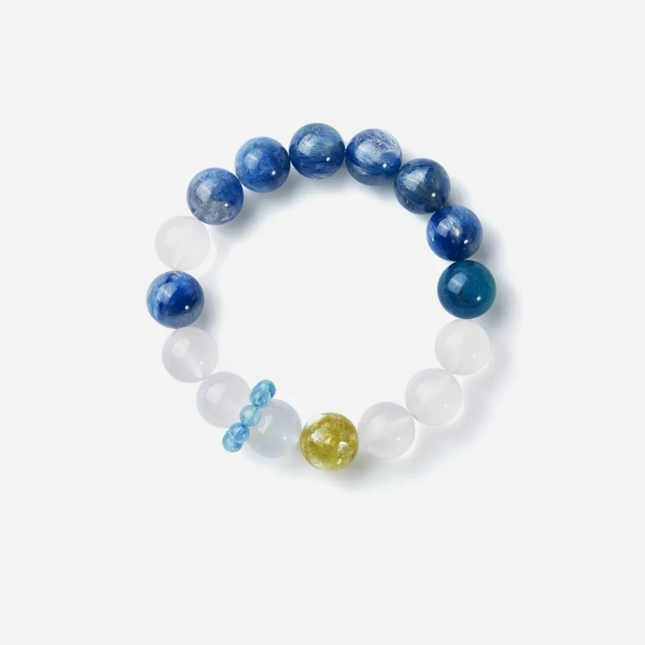 Top-down flatlay showing the artistic asymmetrical color blocking of deep blue, soft white, and bright yellow