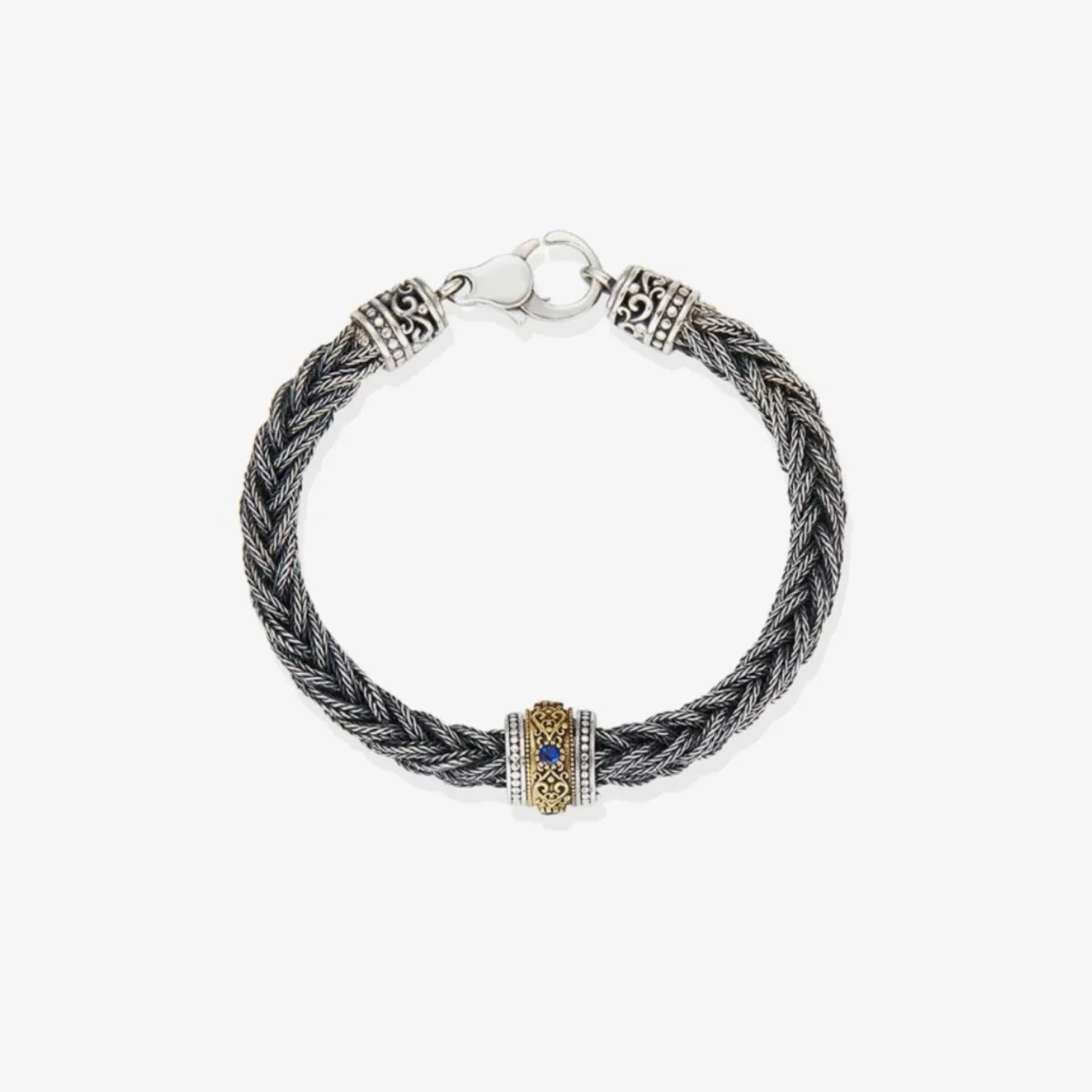 Top-down view highlighting the deep blue gemstone set within the golden bronze scrollwork