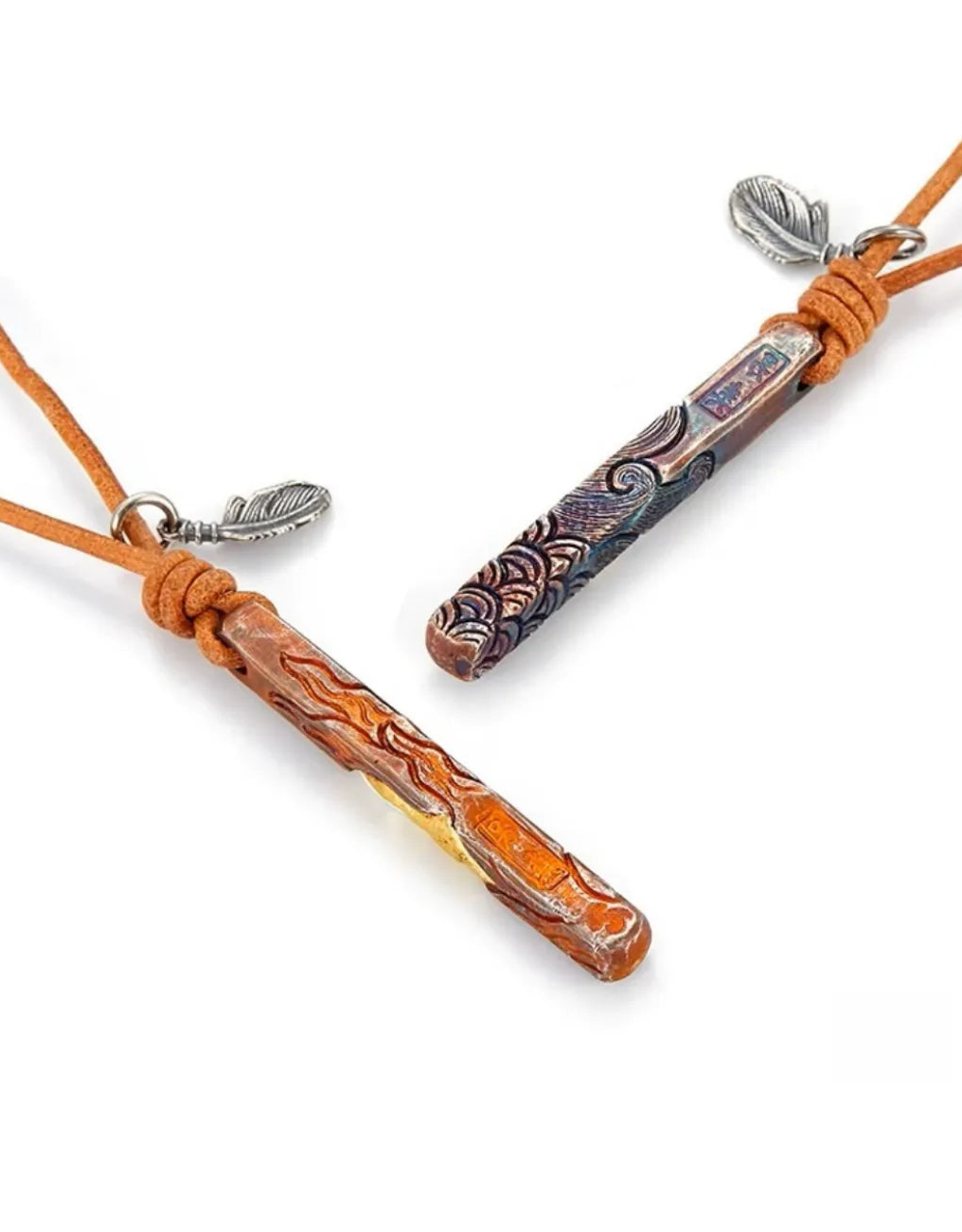 Angled shot of the Water and Fire bar pendants showing the wave and lava textures with gold accents