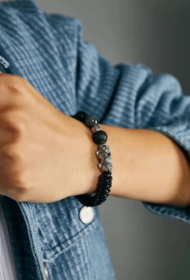 A candid shot showing the bracelet's profile, blending rugged lava textures with the sheen of semi-precious stones