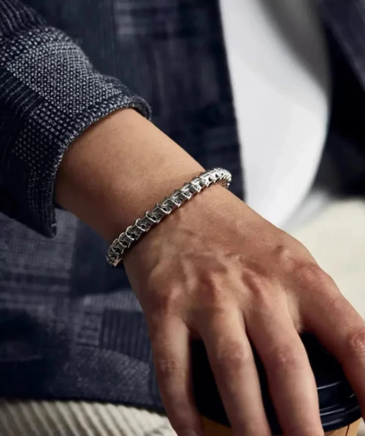 Close-up of the wrist showing the adjustable cord mechanism and the bone tail charm dangling