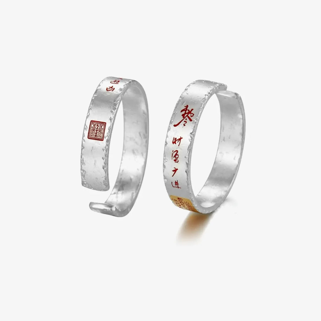 Top-down view highlighting the contrast between the matte silver body and the vivid cinnabar red calligraphy