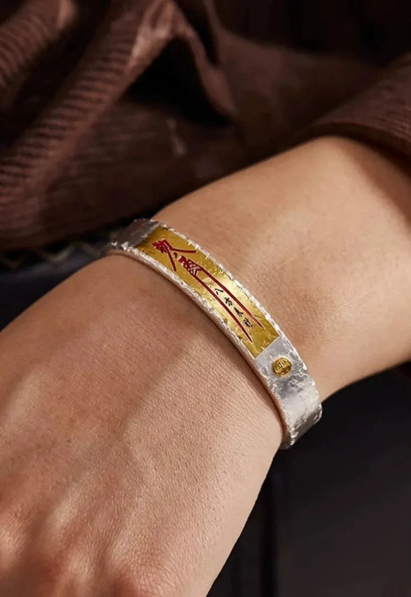 Close-up on the wrist showing the 'Ba Fang Lai Cai' (Wealth from All Directions) red calligraphy clearly against the skin