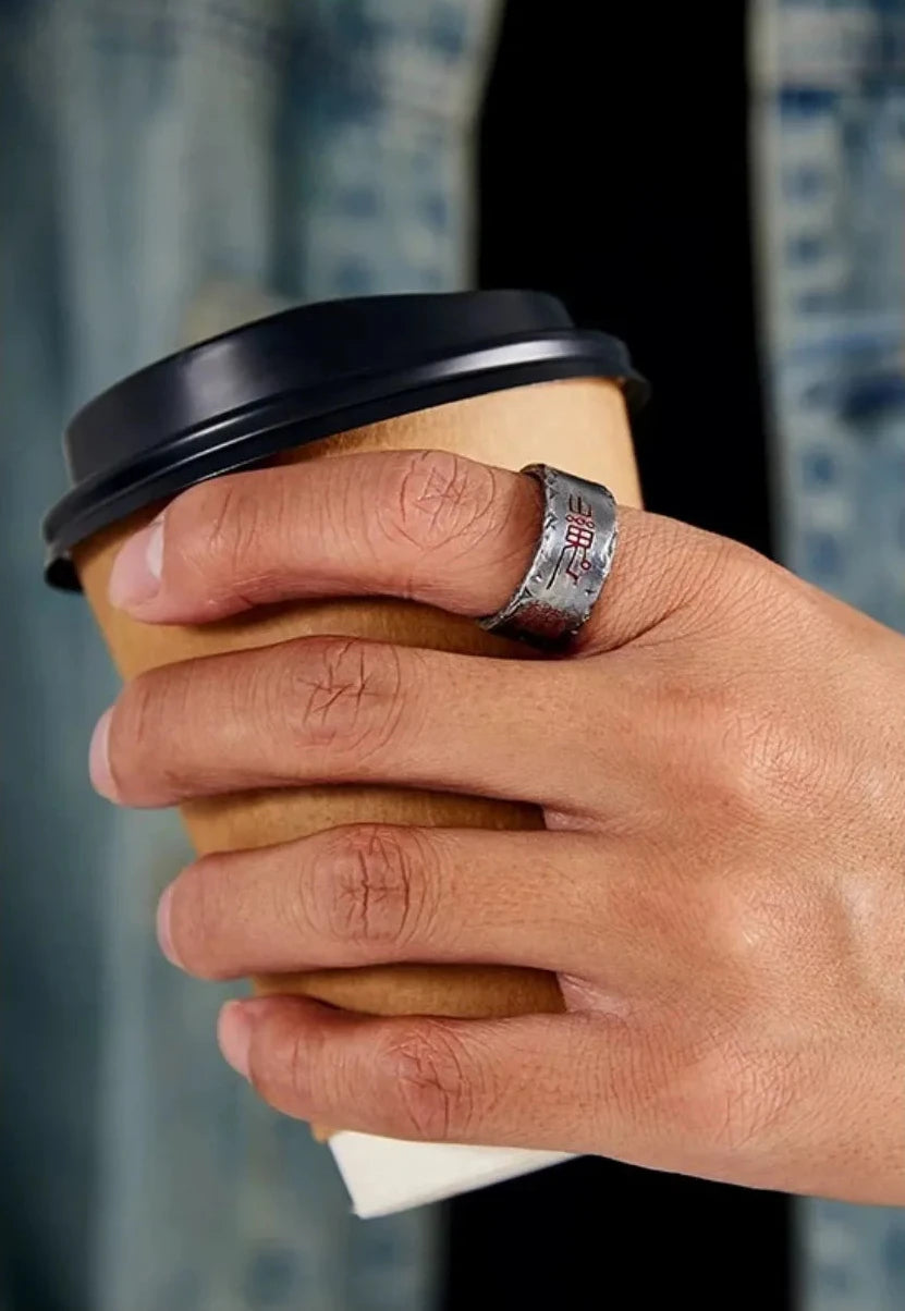 Lifestyle shot of the silver Taoism ring with cinnabar details, matched with a casual denim outfit