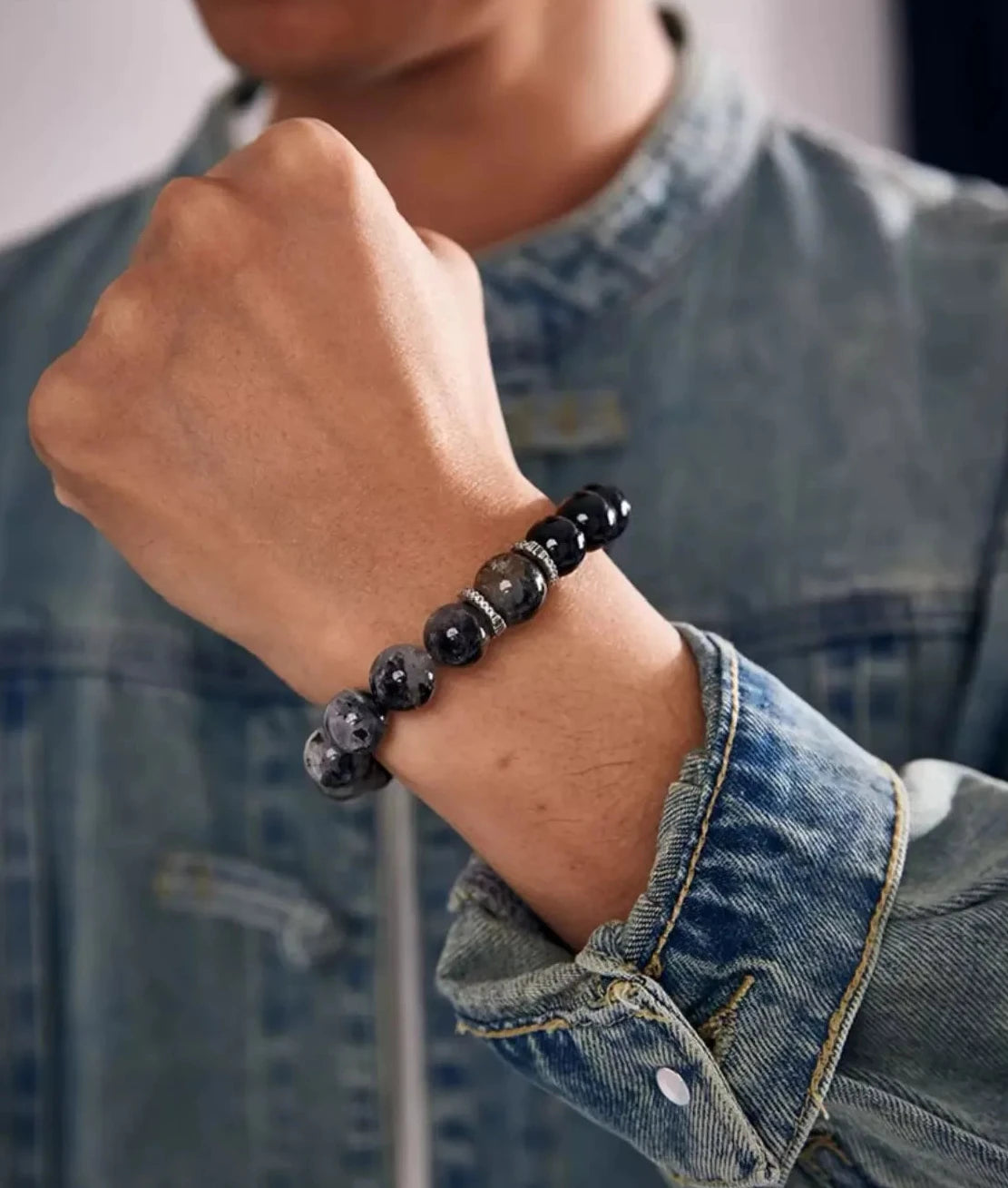 A powerful fist shot highlighting the "Vanquisher" concept, with the black needles in the quartz visible under natural light