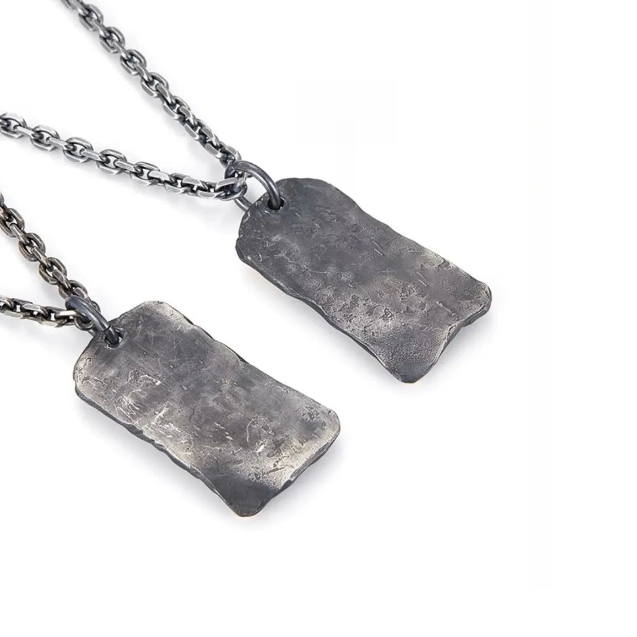 Close-up of the silver tablet pendant engraved with oracle script and inlaid with a golden bronze coin