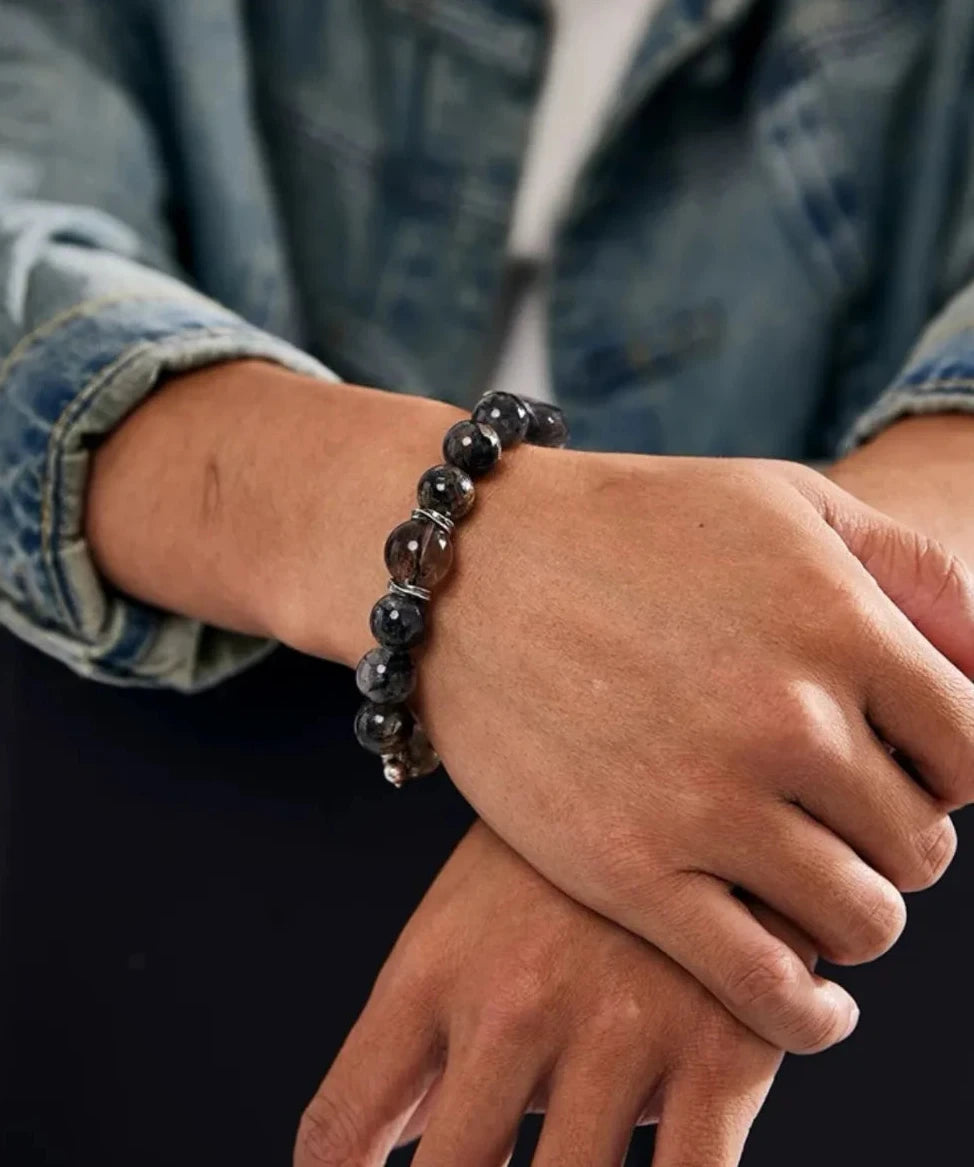 A natural interaction shot, showing how the dark quartz beads complement casual, everyday fashion