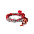 Front view of the Ignite Fortune bracelet, featuring three ancient silver coins woven into a lucky vermilion red cord