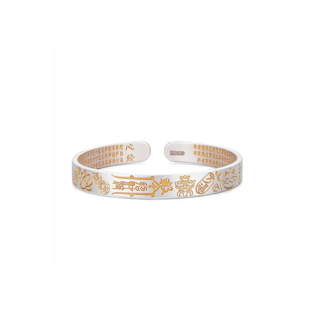 Front view of the Fortune Bangle featuring gold auspicious symbols and engraved Heart Sutra text on the inner band