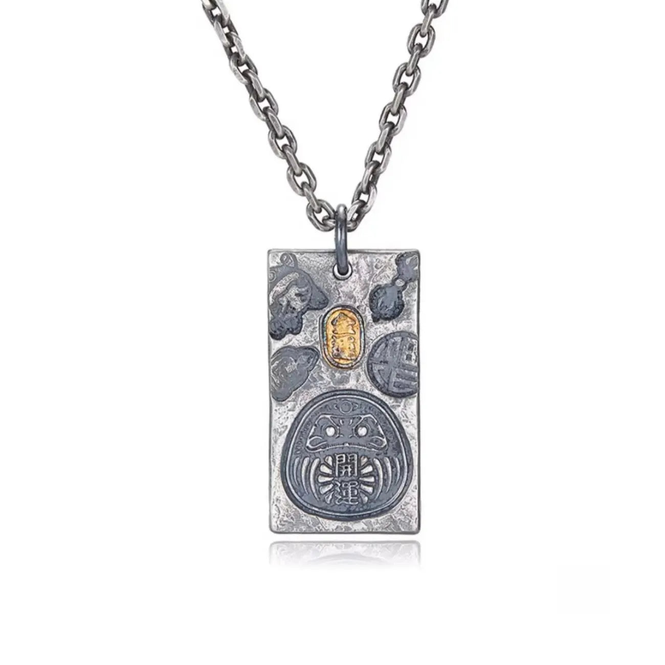 Front view of the Fortune Key necklace featuring a silver Daruma amulet with gold and bronze accents