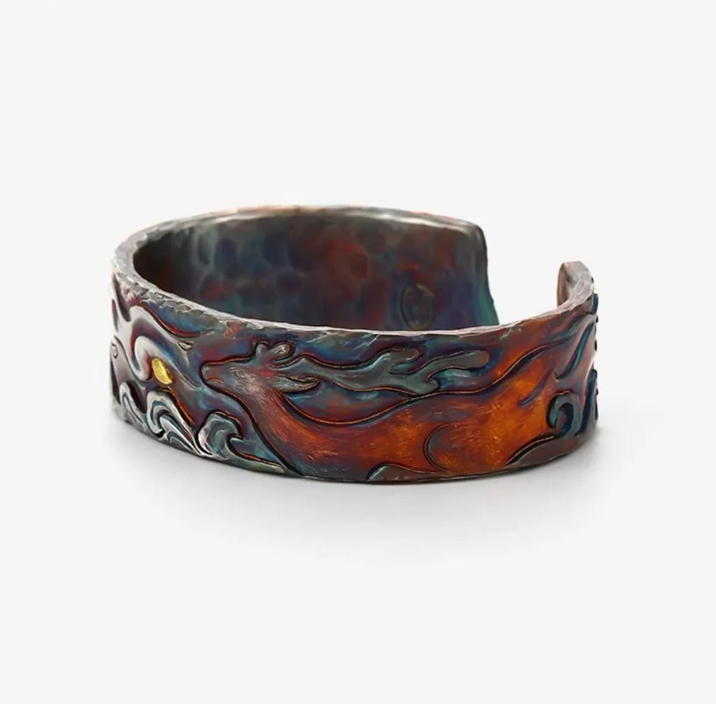 Top-down view highlighting the small gold leaf accent contrasting with the stormy blue cloud motifs