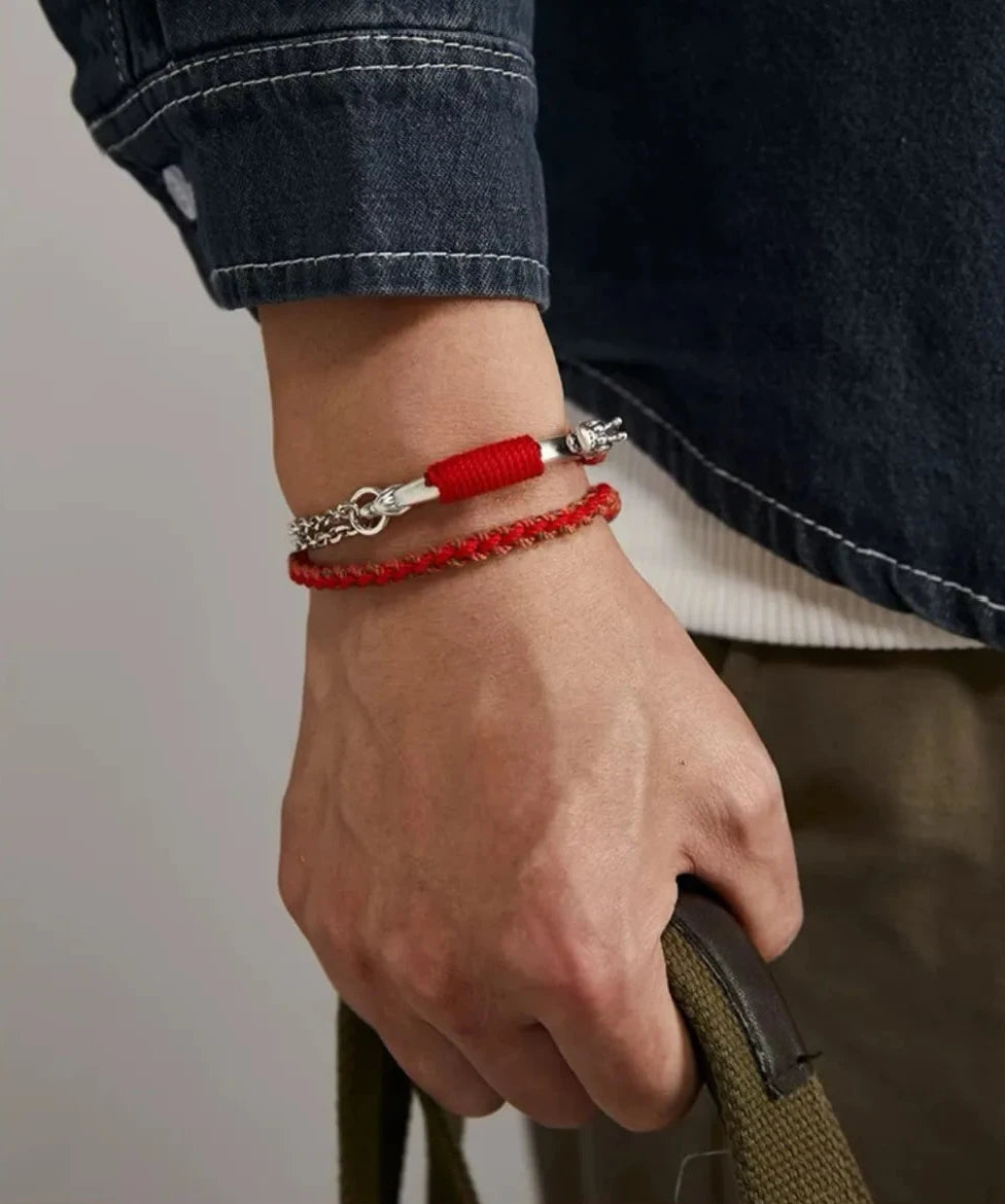 Lifestyle shot showing how the red serpent bracelet adds a pop of color to a classic denim outfit