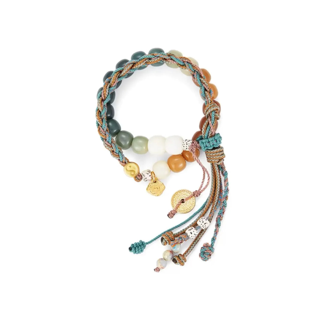 Front view of the Taoism Naturally bracelet featuring gradient green and amber beads with a gold Yin Yang charm