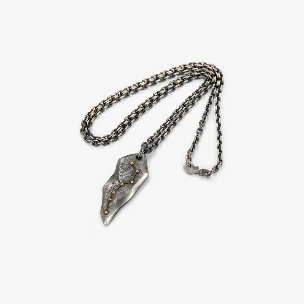 Flat lay of the necklace showing the sturdy chain and the unique rock-shaped pendant design