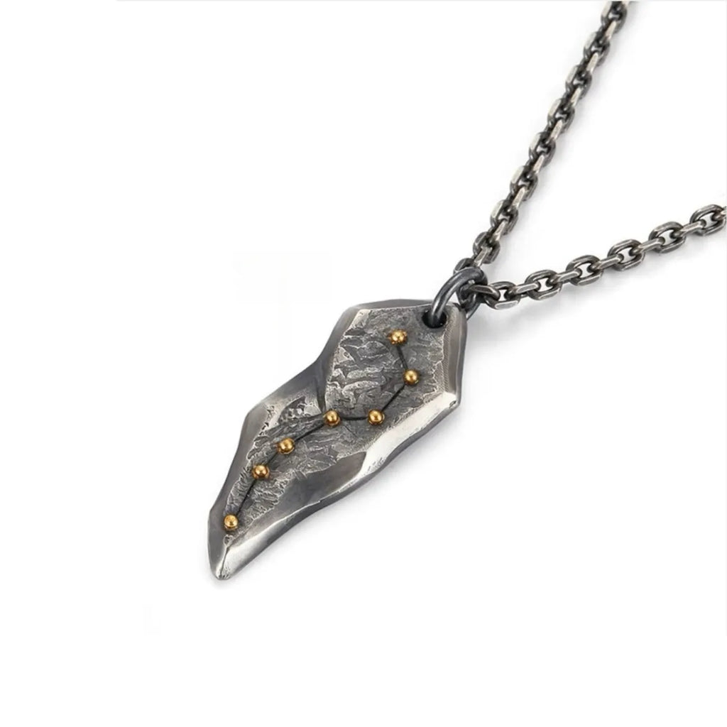 Angled shot showing the rugged, meteorite-like texture of the oxidized silver pendant