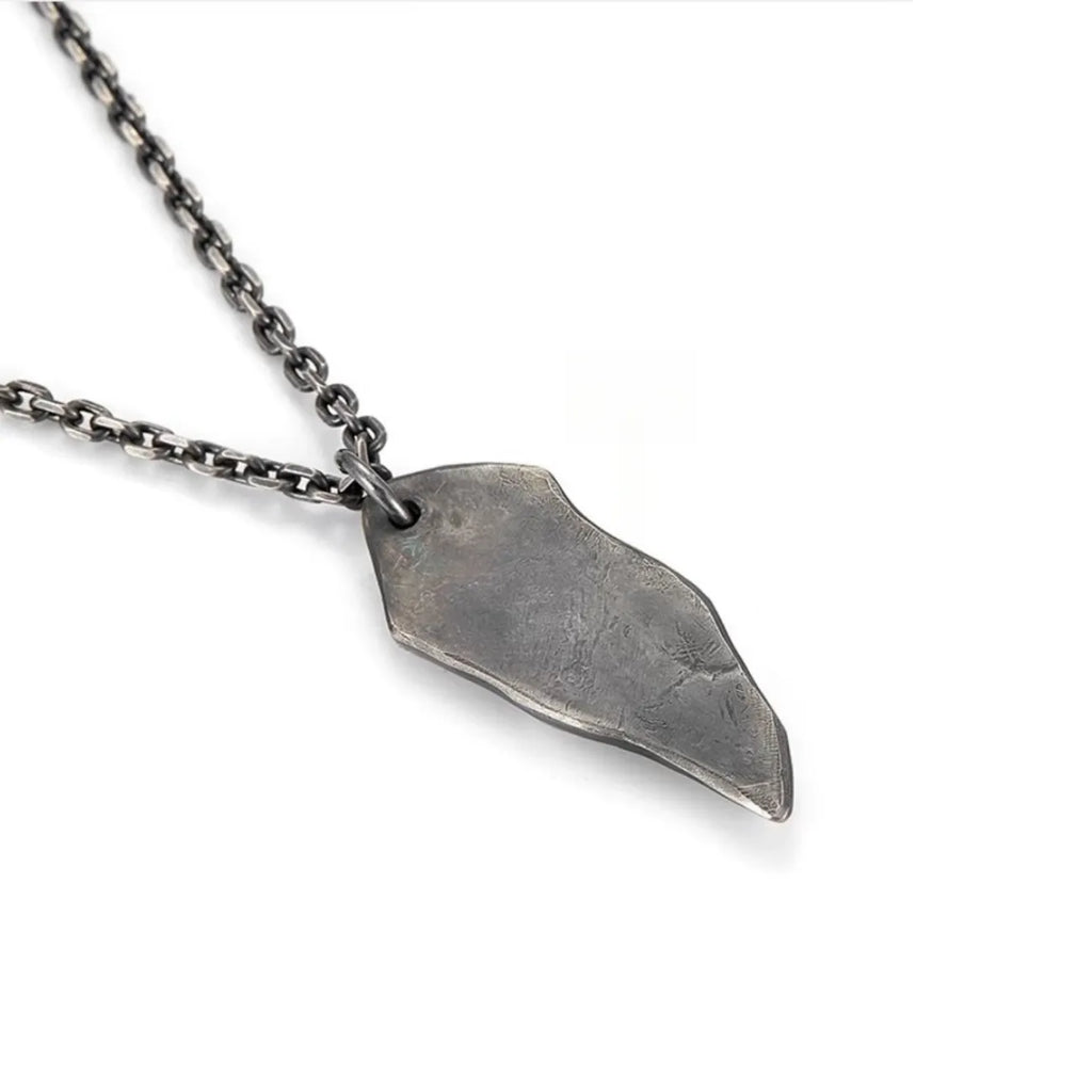 Back view of the pendant displaying a raw, textured surface resembling natural stone or meteorite