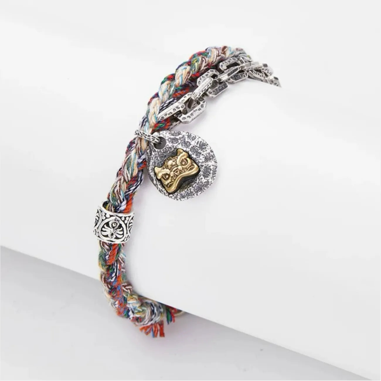 Top-down macro shot highlighting the intricate craftsmanship of the silver tube beads and the vibrant colors of the cotton cord