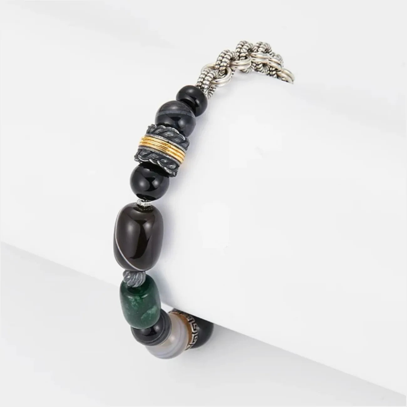 Side profile highlighting the mixed metal spacer bead with gold rings and the large black banded agate stone