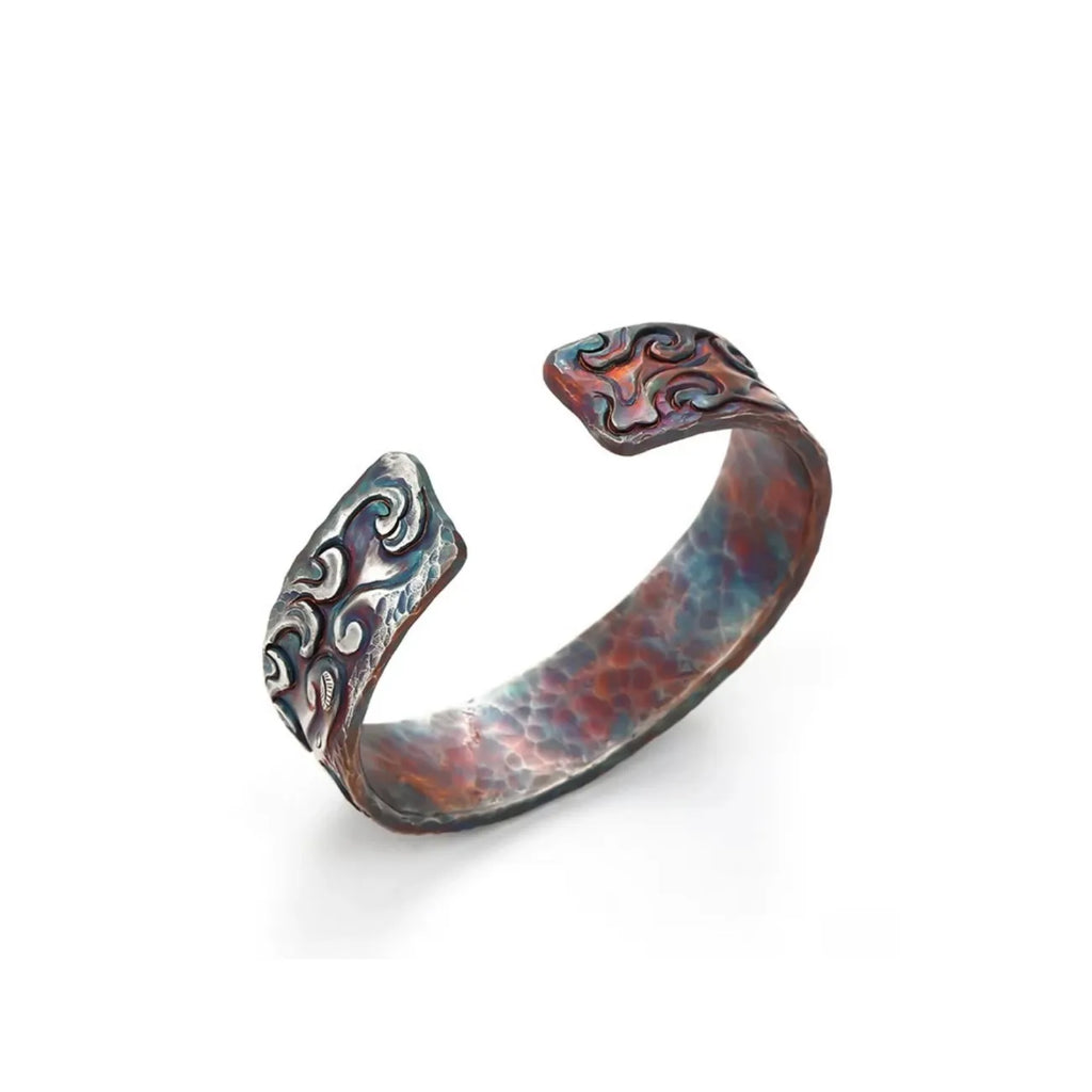 Back view displaying the open cuff design and the textured hammered silver interior craftsmanship