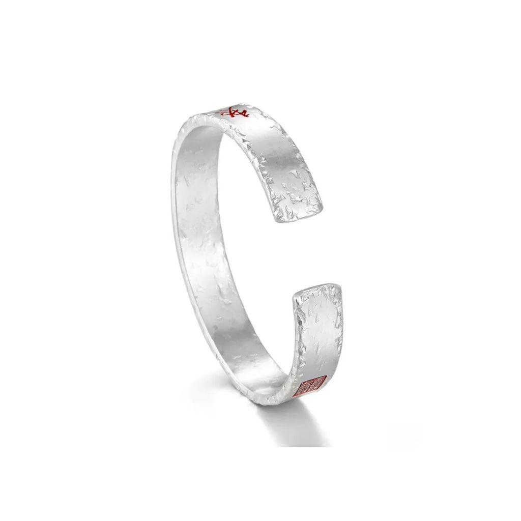 Side profile showing the rustic hammered silver texture and the adjustable open-ended design of the bangle