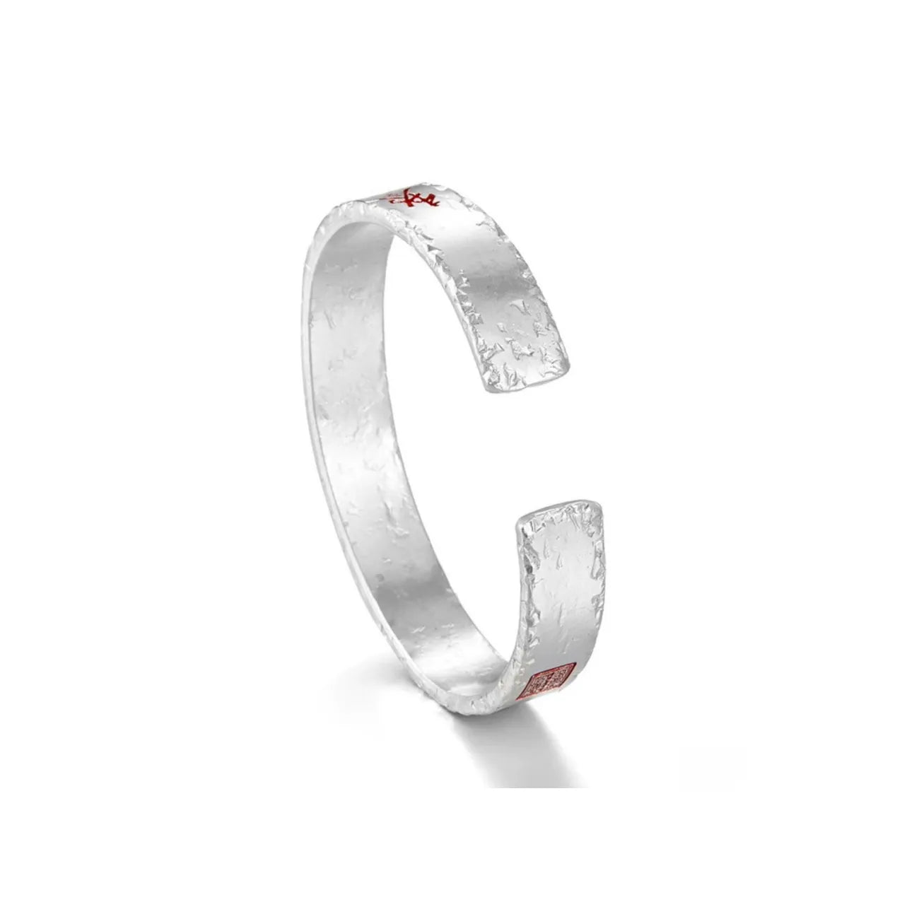 Side profile showing the rustic hammered silver texture and the adjustable open-ended design of the bangle