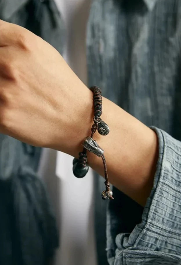 A powerful close-up of the "Bone" slider and green beads, symbolizing the concept of "Spring" and rebirth from the old