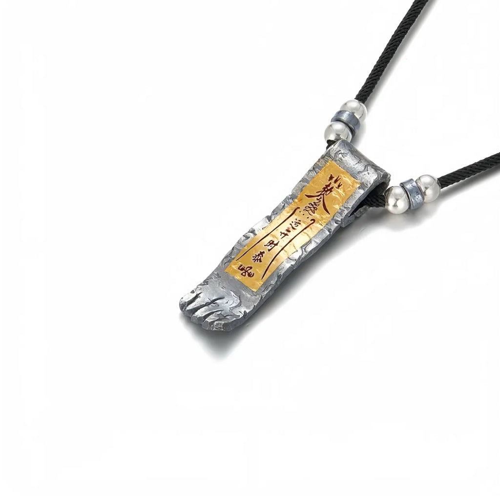 Side profile showing the handcrafted hammered texture of the silver charm