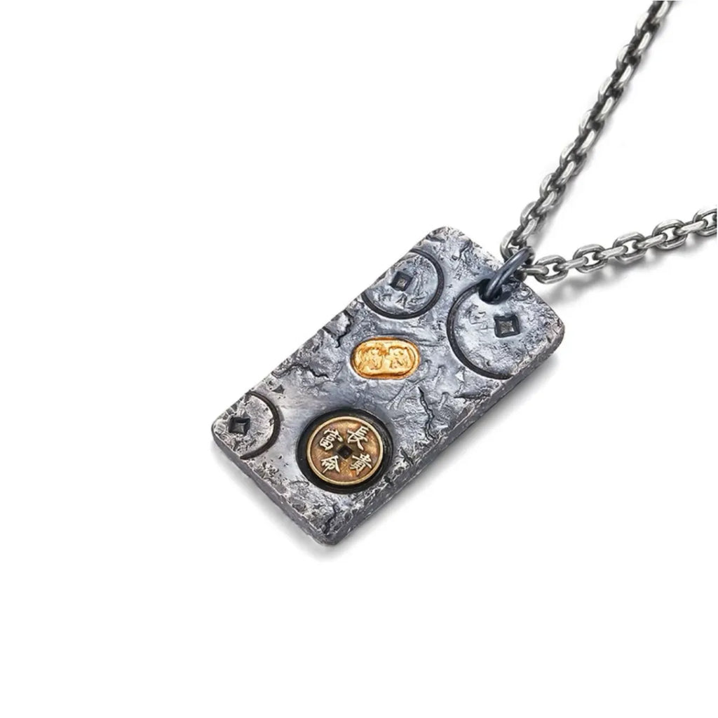Angled side view of the handcrafted silver pendant highlighting the thick, rugged edges and distressed crater texture