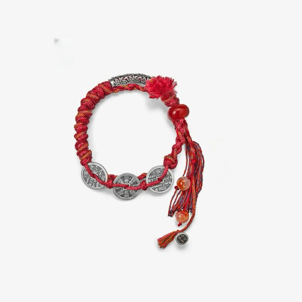 Top-down view of the circular red woven bracelet, displaying the detailed knotting work and silver accents