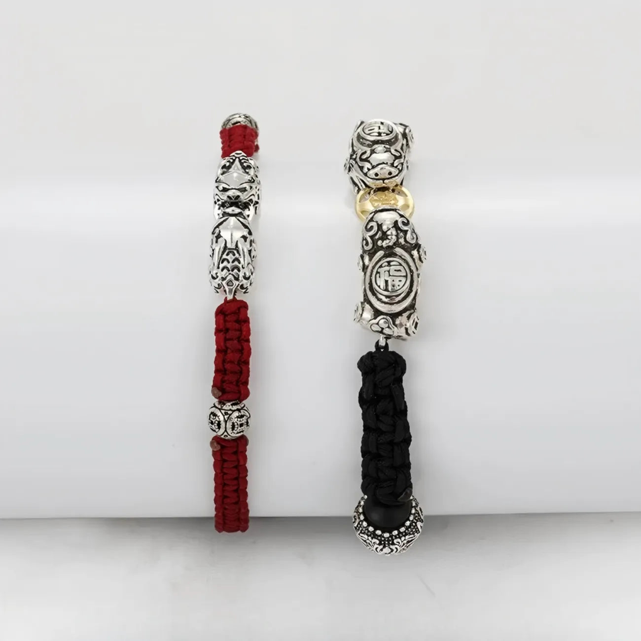 Lifestyle flatlay on a vintage wooden table, presenting the red and black Pixiu bracelets as a perfect meaningful gift for anniversaries or Valentine's Day