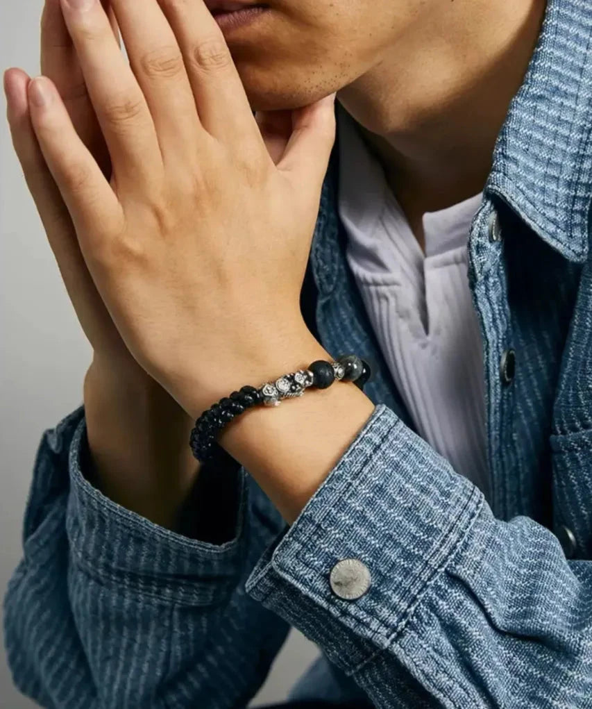 Clasping hands pose emphasizing the bracelet as a symbol of focus, vision, and grounded energy