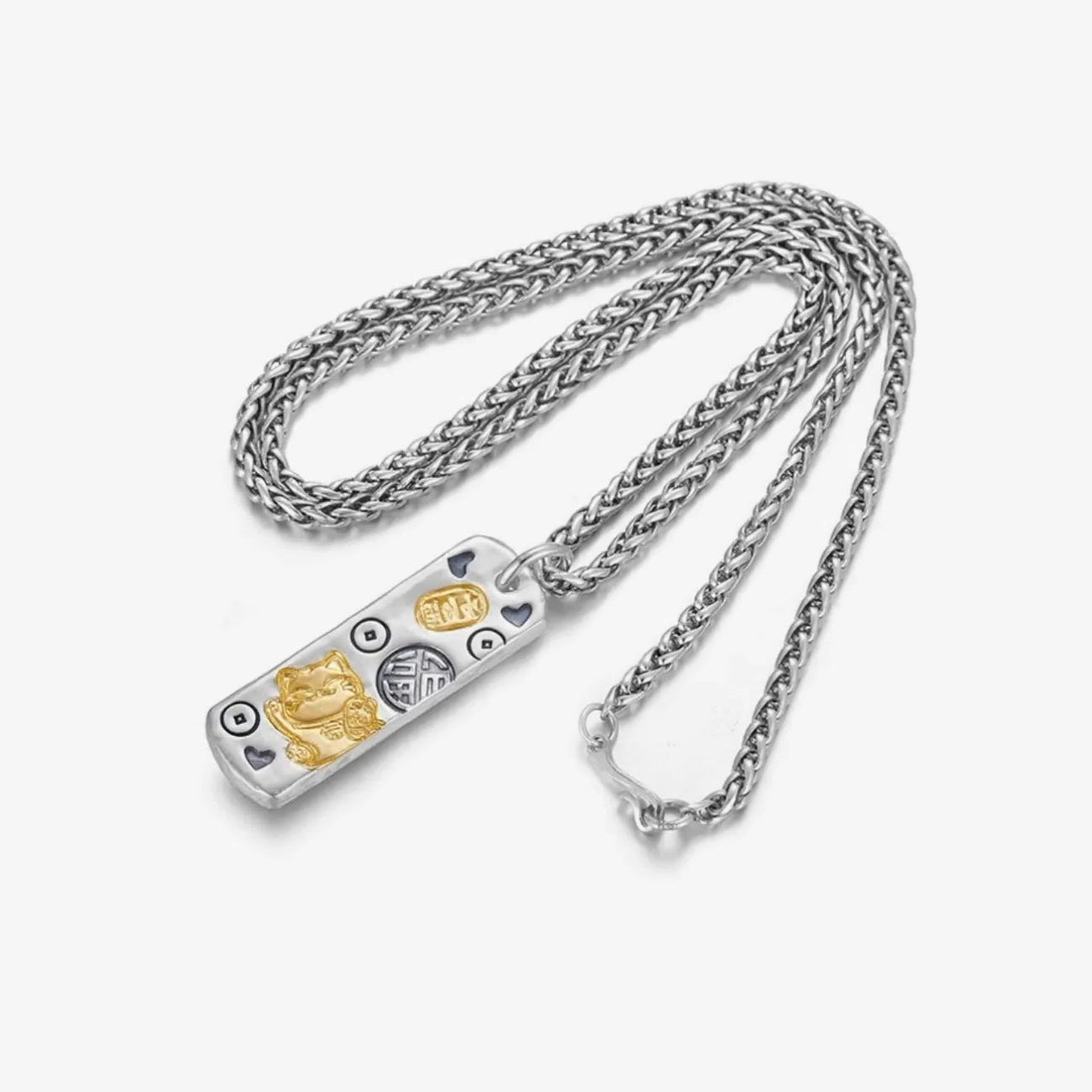 Flat lay of the lucky cat necklace featuring a maneki-neko and gold ingot relief on a silver tag