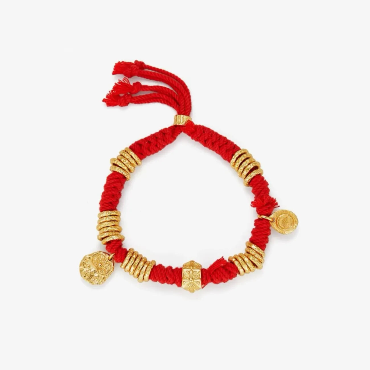 Top-down view highlighting the central floral gold bead and the symmetrical arrangement of gold coils