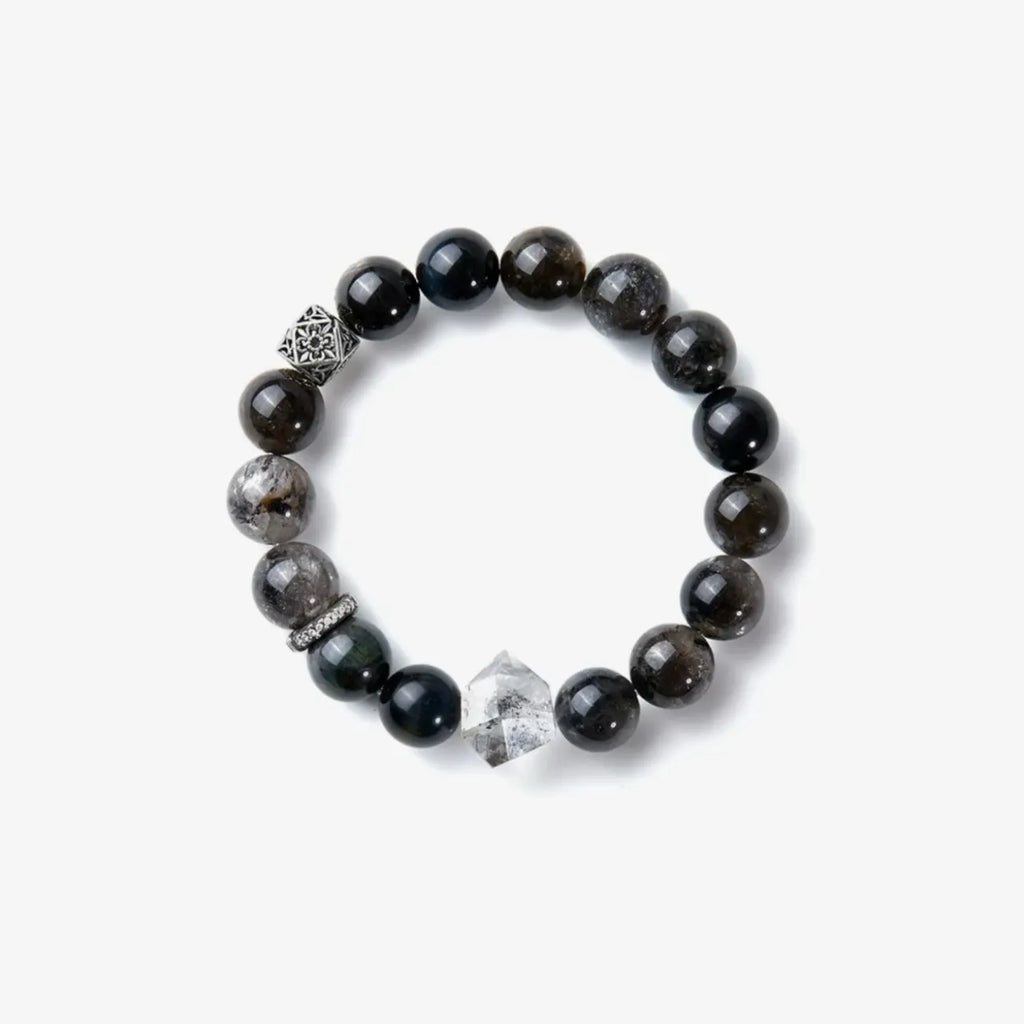 Top-down view displaying the full arrangement of blue tiger eye beads and silver accents on a white background