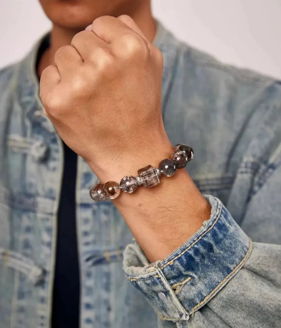 Lifestyle shot showing the Taotie silver bead resting against the wrist, symbolizing protection from negative energy