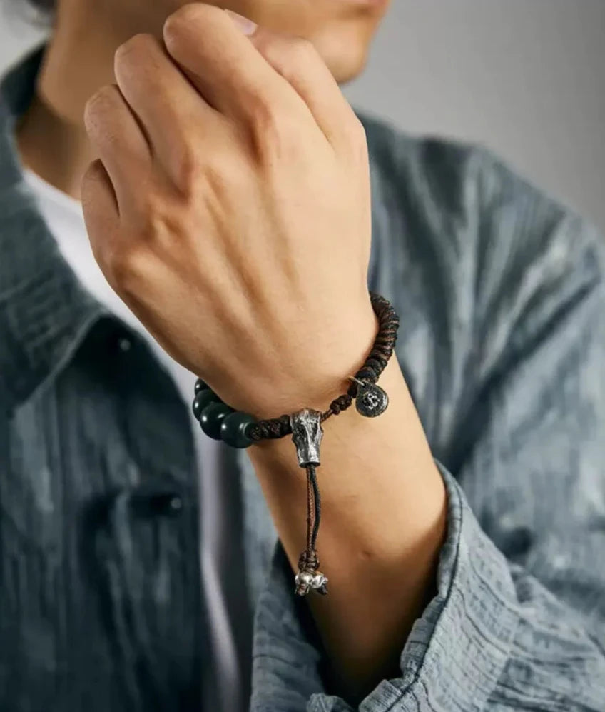 Lifestyle shot showing the deep green Bodhi beads popping against casual workwear, perfect for everyday style