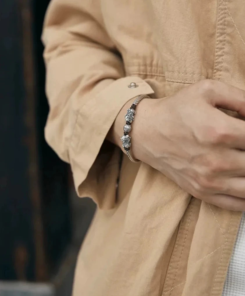 Close-up of the bracelet tucked near a pocket, emphasizing the "Fortune Keeper" symbolism and premium craftsmanship