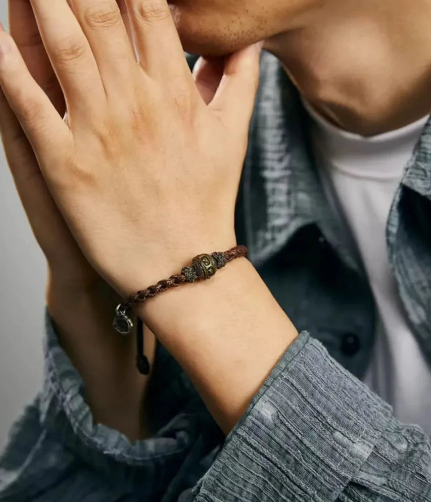 A contemplative shot of a man with clasped hands, emphasizing the bracelet's role as a symbol of inner peace and focus