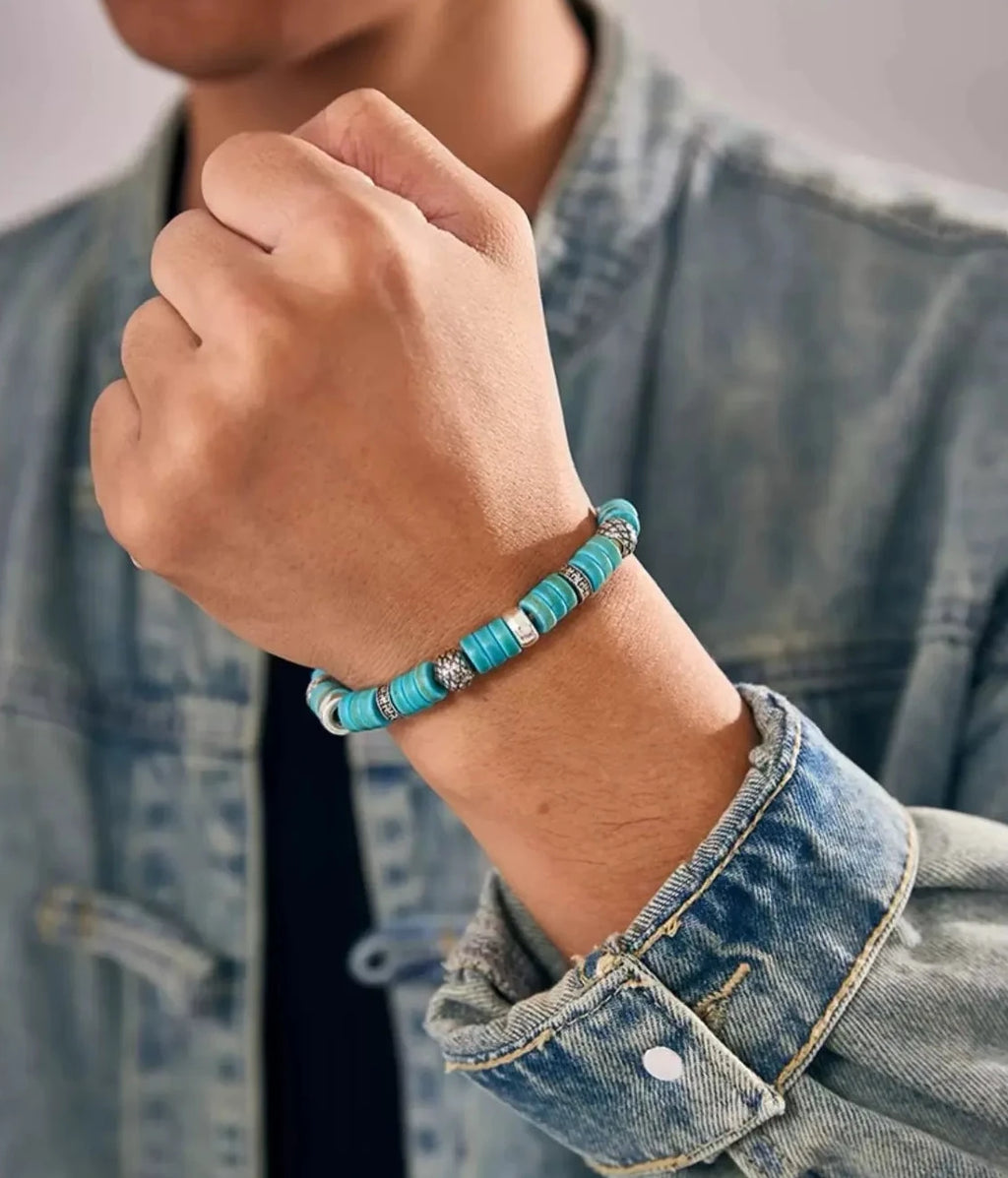 A close-up of a clenched fist, presenting the Blessing Bracelet as a symbol of strength and good fortune for the modern adventurer