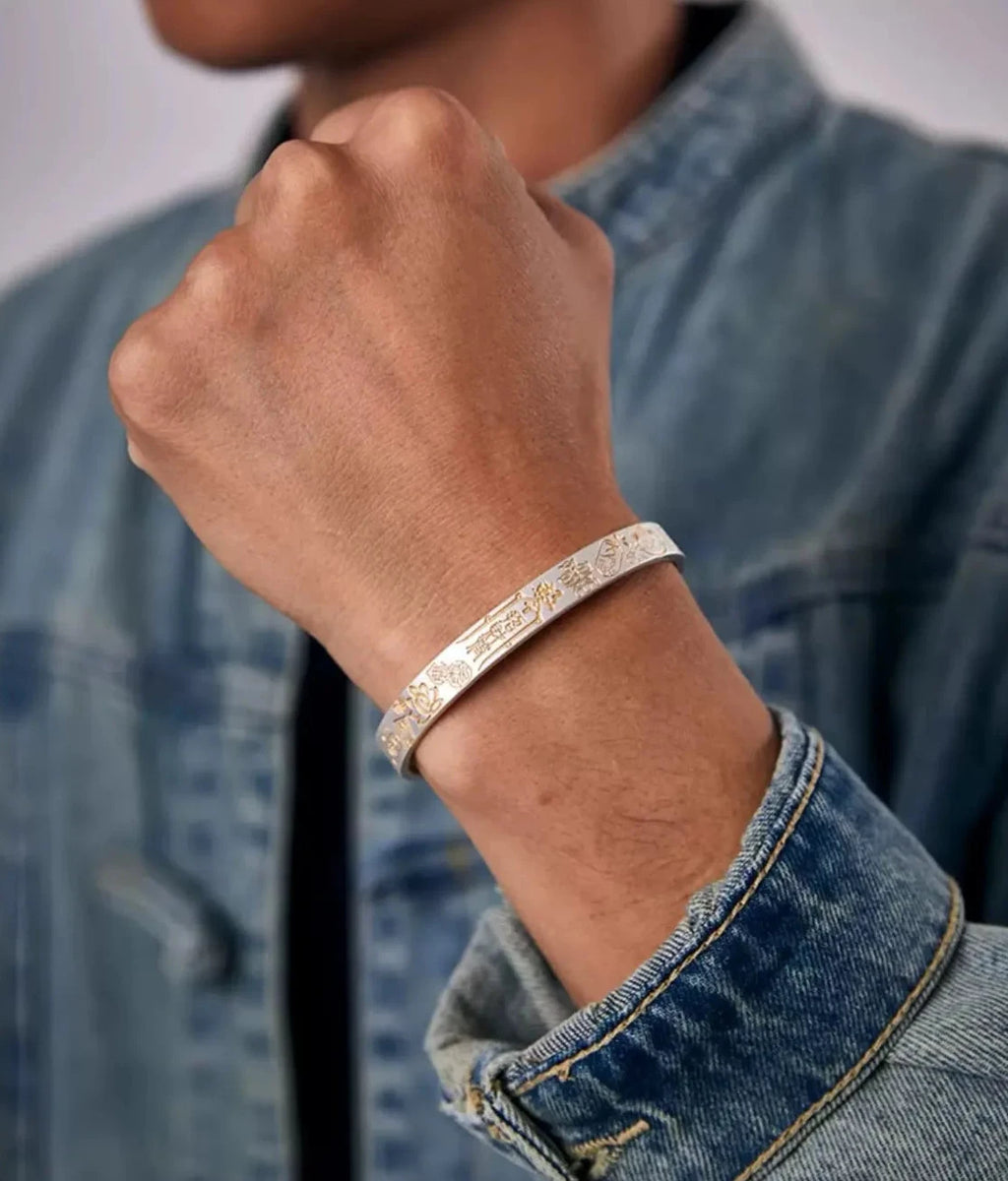 Strong fist pose showcasing the "Zhao Cai Jin Bao" (Wealth) characters on the bangle, symbolizing power and prosperity