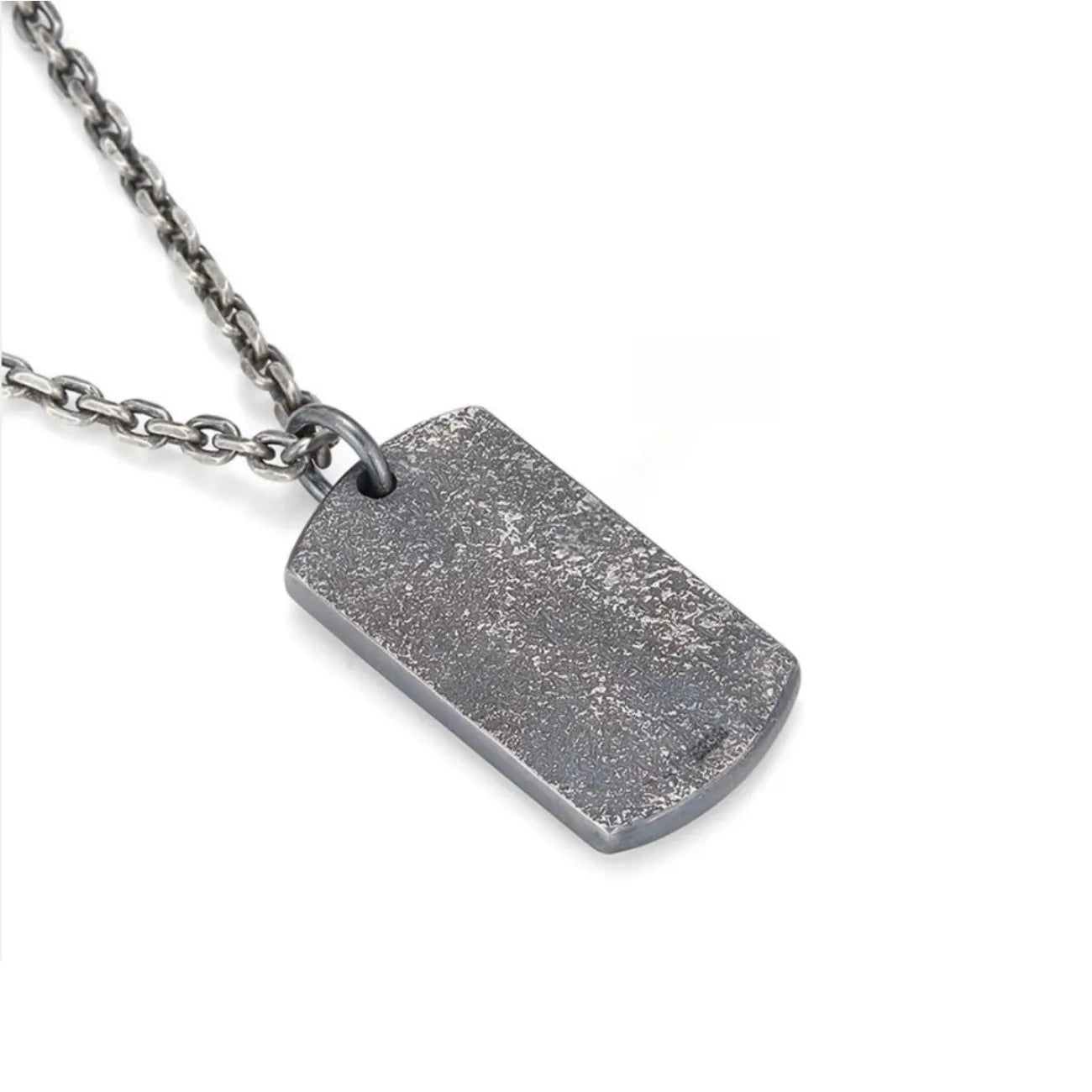 Back view of the silver Fortune pendant showcasing the rugged, stone-like textured surface
